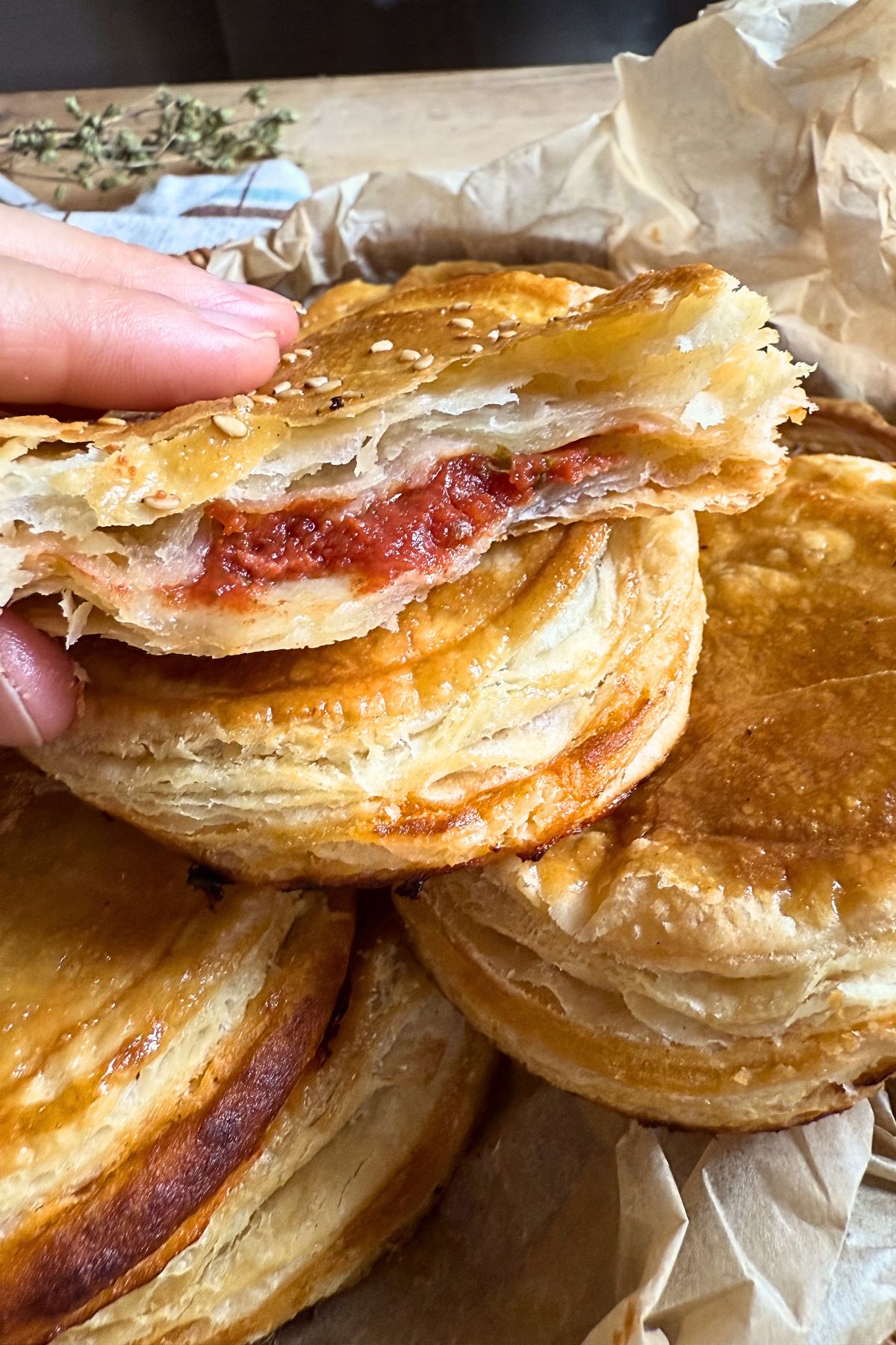 Pizzette Cagliaritane torn apart with tomato filling.