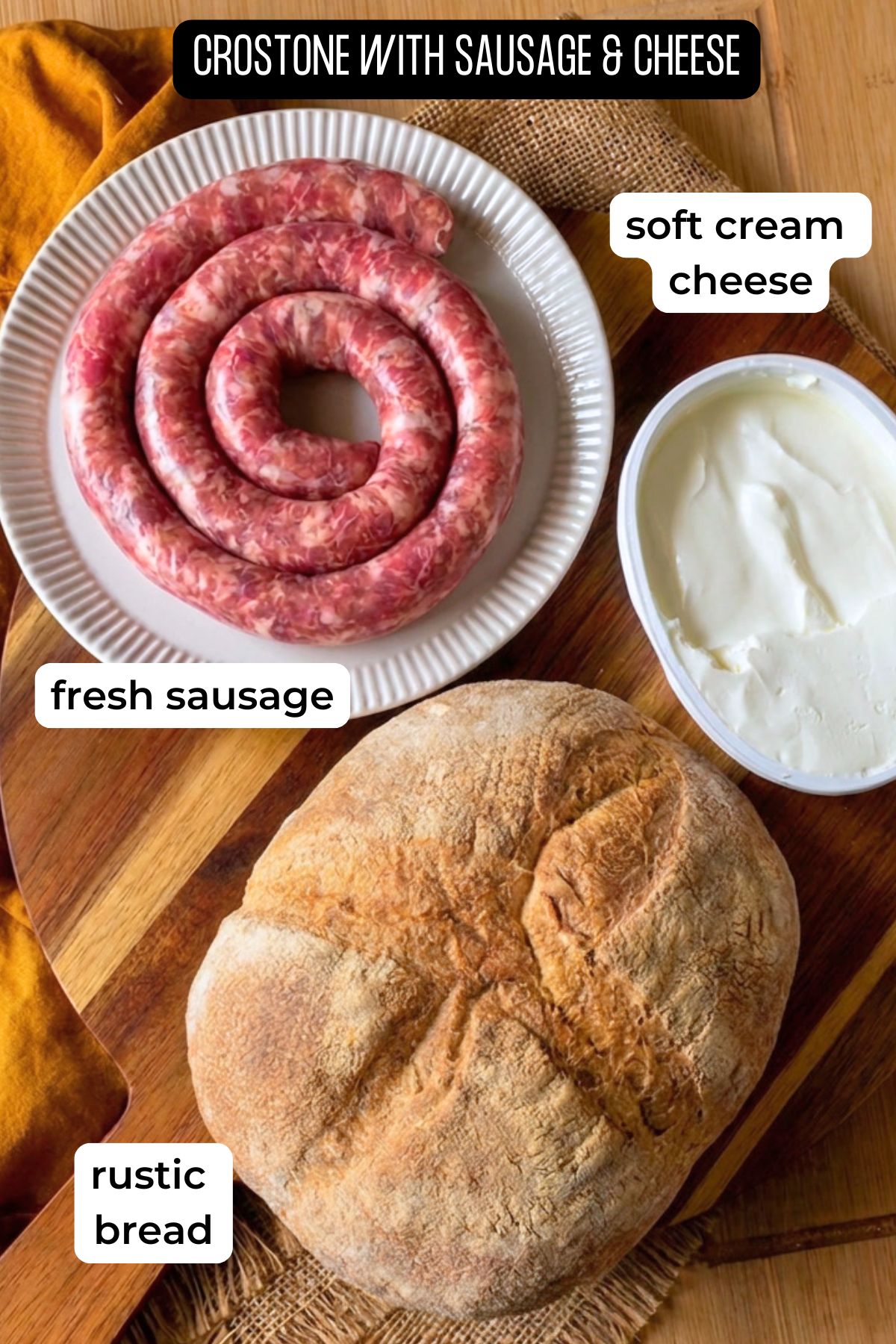 Ingredients for sausage crostone laid on a wooden board.